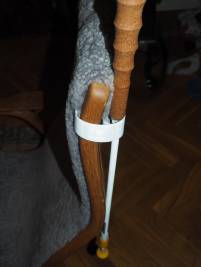 Bild på käppen fastsatt med käpphållaren på ryggstödet på en fåtölj